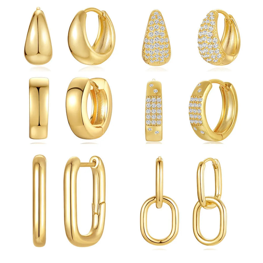 A pair of golden brass diamond-shaped earclip earrings with a round geometric design.