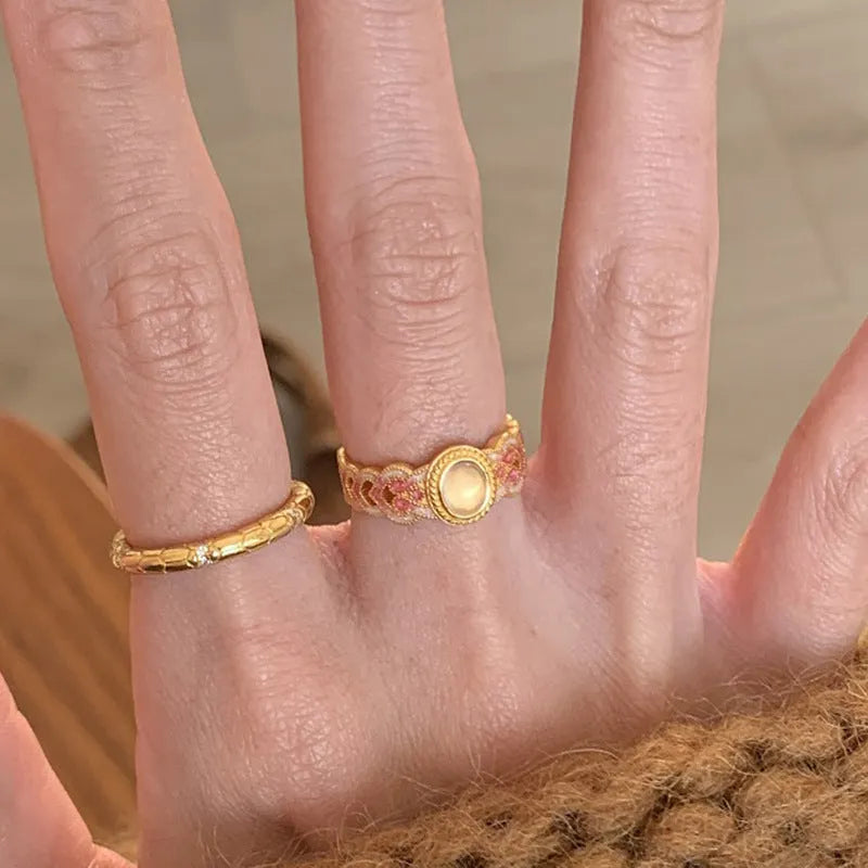 Women's open mouth ring with geometric shape, gold plating, and pink crystal enamel accents