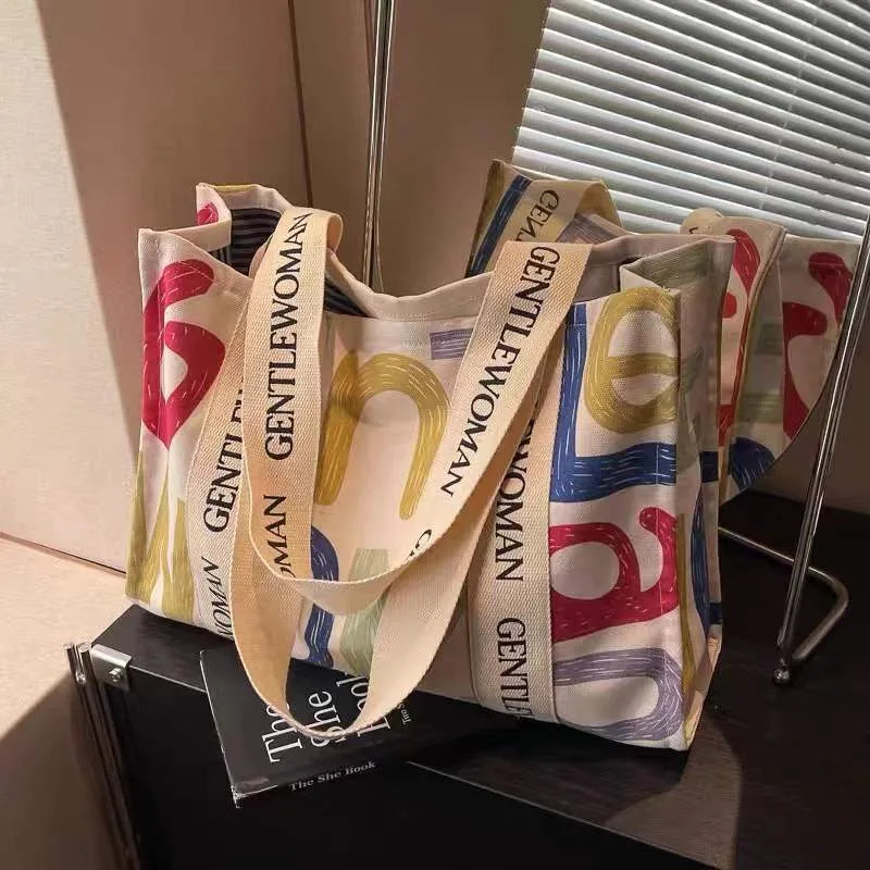 Canvas women's travel tote shopping bag with printed design in unisex style