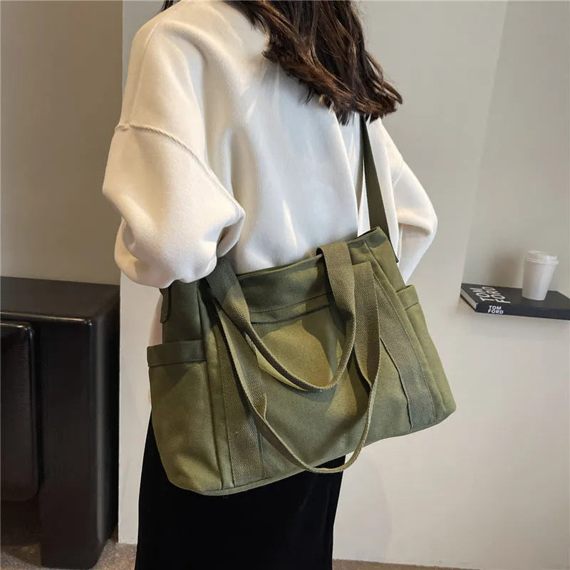 Women's polyester canvas shoulder tote bag in solid colour with exterior sandwich pocket