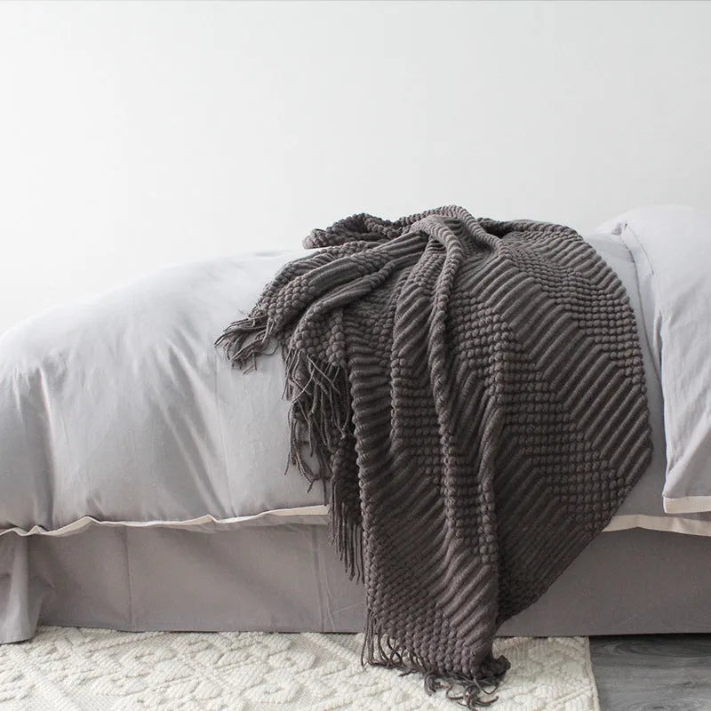 Small polyester nap blanket in dark grey, khaki, or light grey measuring 127x170cm