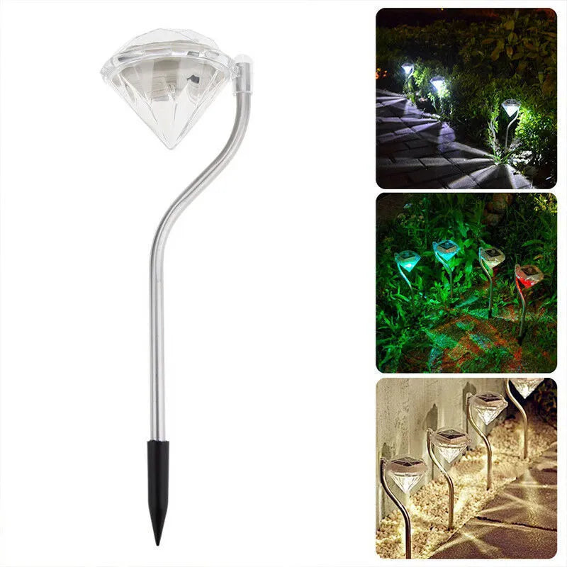 Solar powered diamond-shaped garden spotlight with adjustable angle on a grassy lawn.