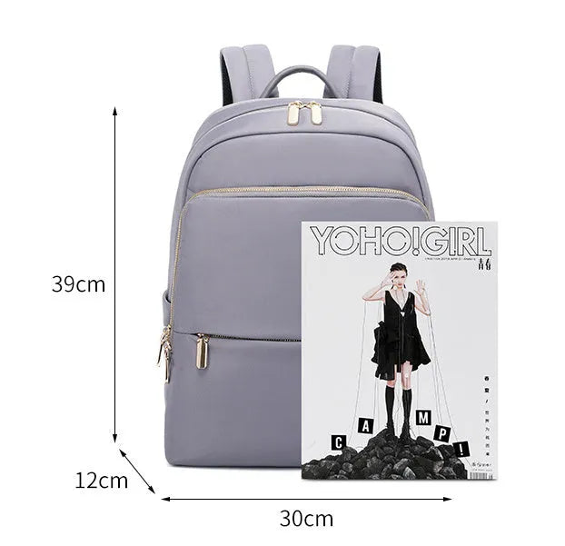 Large black and purplish grey Oxford cloth women's backpack showing anti-theft compartments and breathable back.
