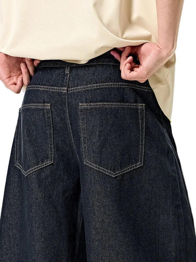 Men's wide leg cotton denim trousers in original cow colour, shown laid flat.