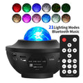 Black USB Bluetooth starry sky projection lamp with rotating water ripple laser effects on desktop