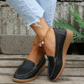 Women's black PU leather flat loafer shoes with a round toe and car suture detail on a white background.