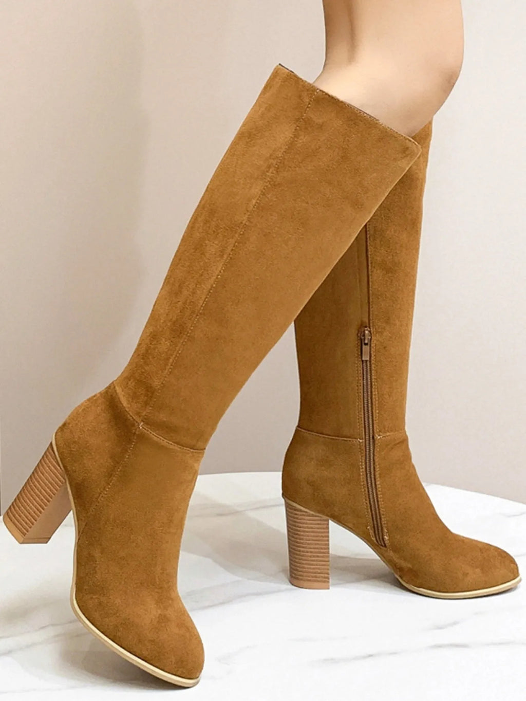 Women's black square toe high heel fashion boot on a white background, showing the artificial PU upper and structured toe shape.