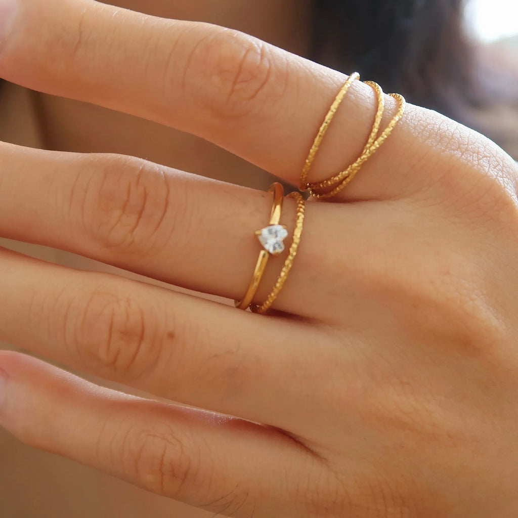 Golden heart shape stainless steel ring with electroplated finish on female hand