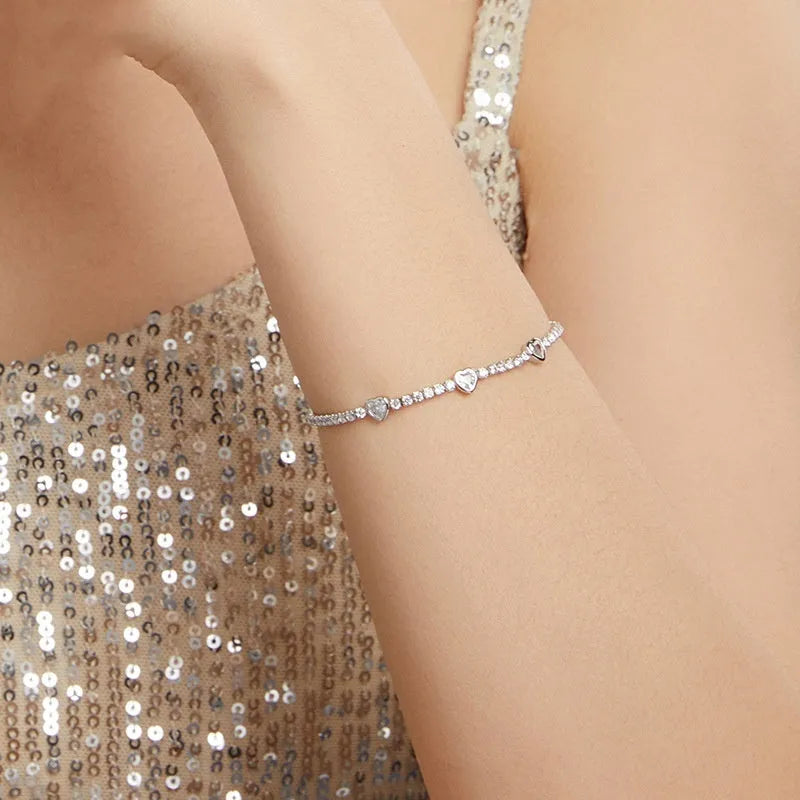 S925 sterling silver bracelet with heart-shaped clear zircon centrepiece on light background
