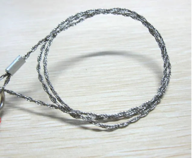 Survival wire saw tool with stainless steel blade and pull rings for outdoor cutting