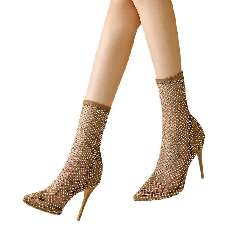 Gold women's stiletto high heel sandals with mesh upper and pointed toe on a rubber sole.