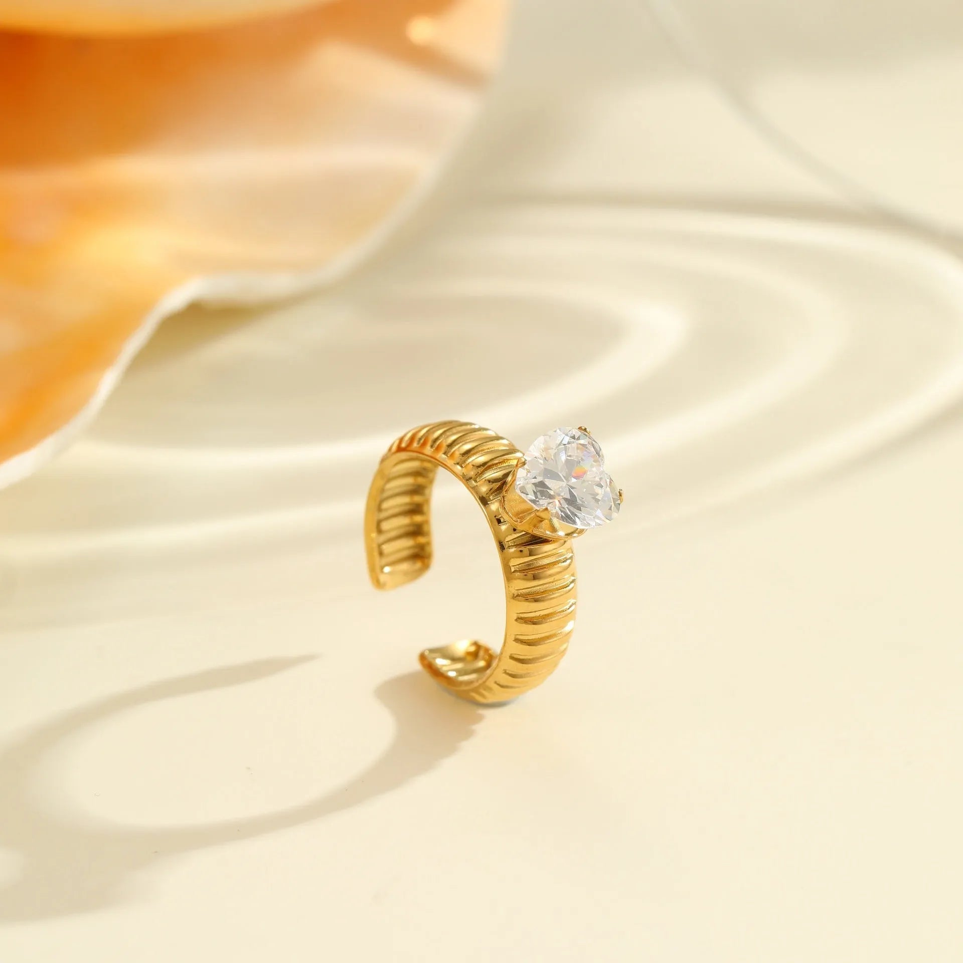 Geometric stainless steel ring with gold inlaid zircon heart shape design