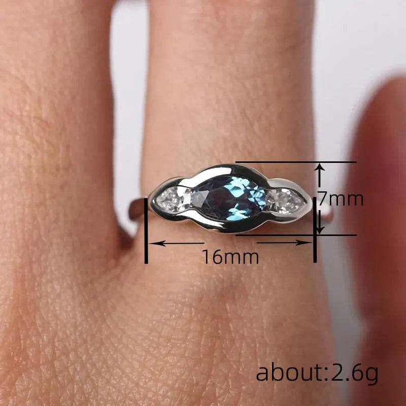 Geometric ellipse ring with inlaid zircon stones in white gold colour finish