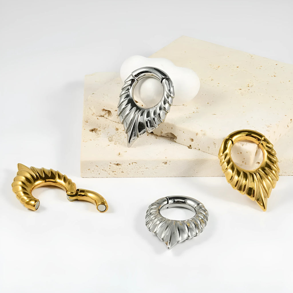 Stainless steel drop-shaped hanging egg ear extender with round tunnel for gauged ears.