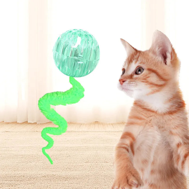 Interactive cat ball toy with plush tail in green, pink, and purple on white background