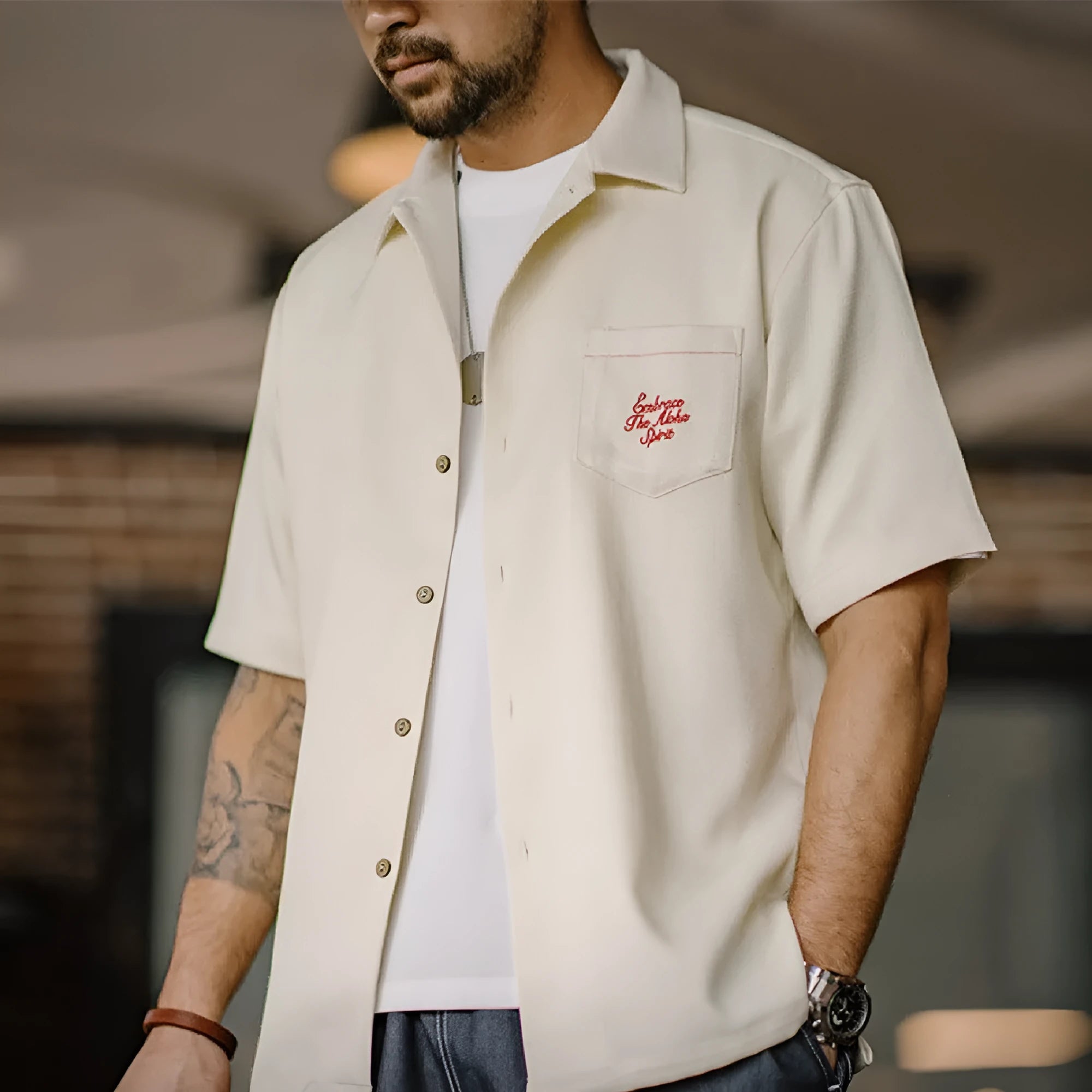 Light apricot men's shirt with bamboo print and a Cuban collar laid flat.