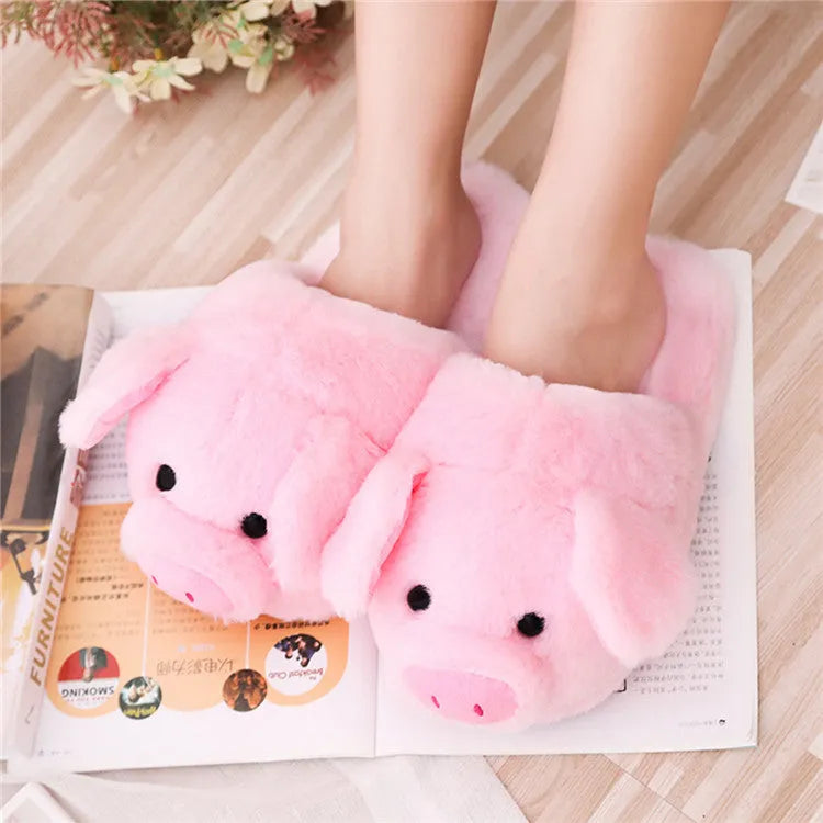 Pink pig floor slippers with plush lining shown on clean indoor surface