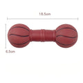Colourful PVC football dumbbell shaped dog toy on a plain background.