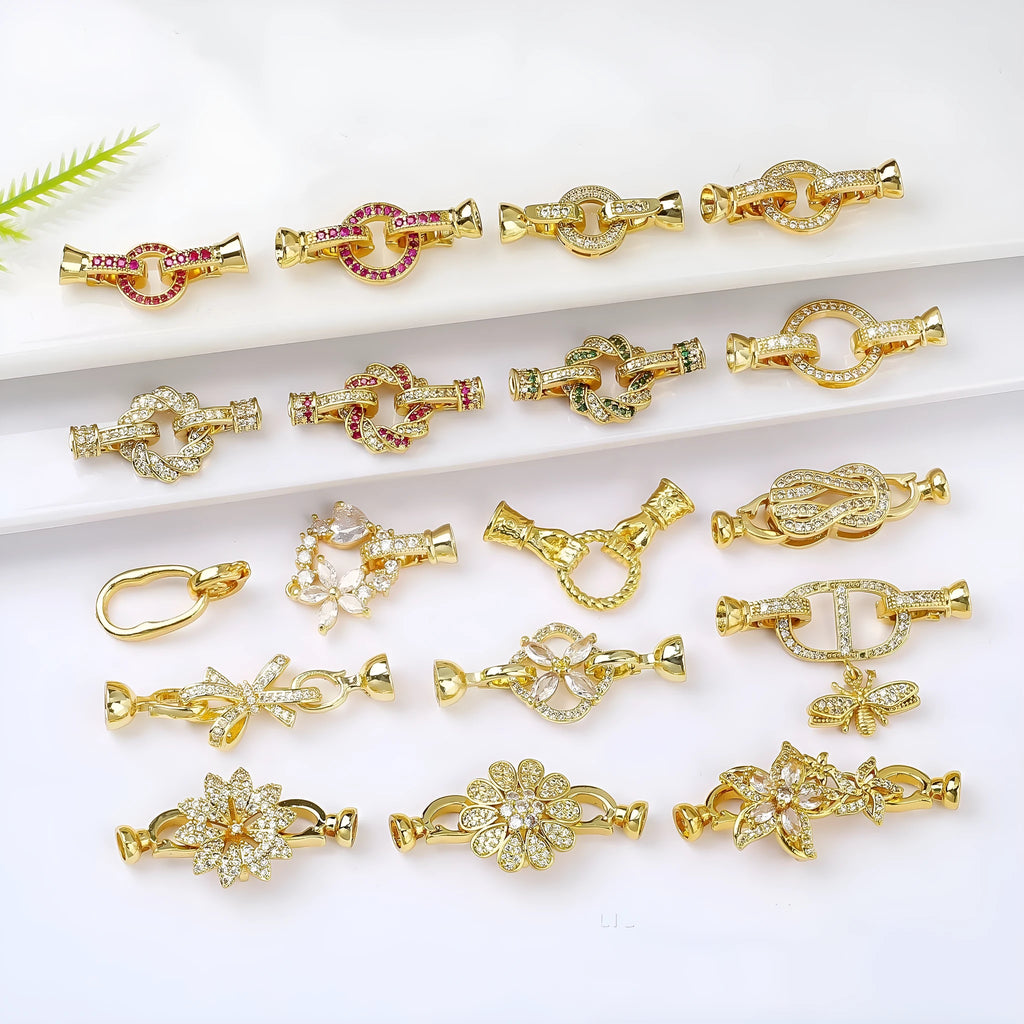 Small gold-coloured metal jewellery clasp on a white background.