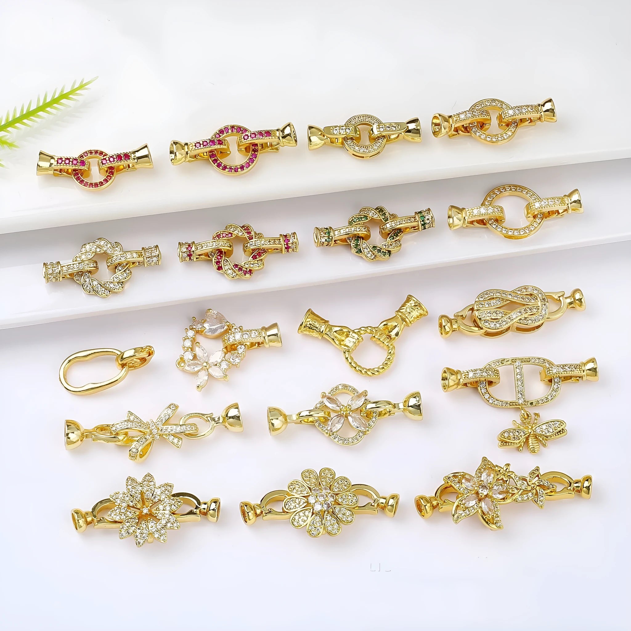 Small gold-coloured metal jewellery clasp on a white background.