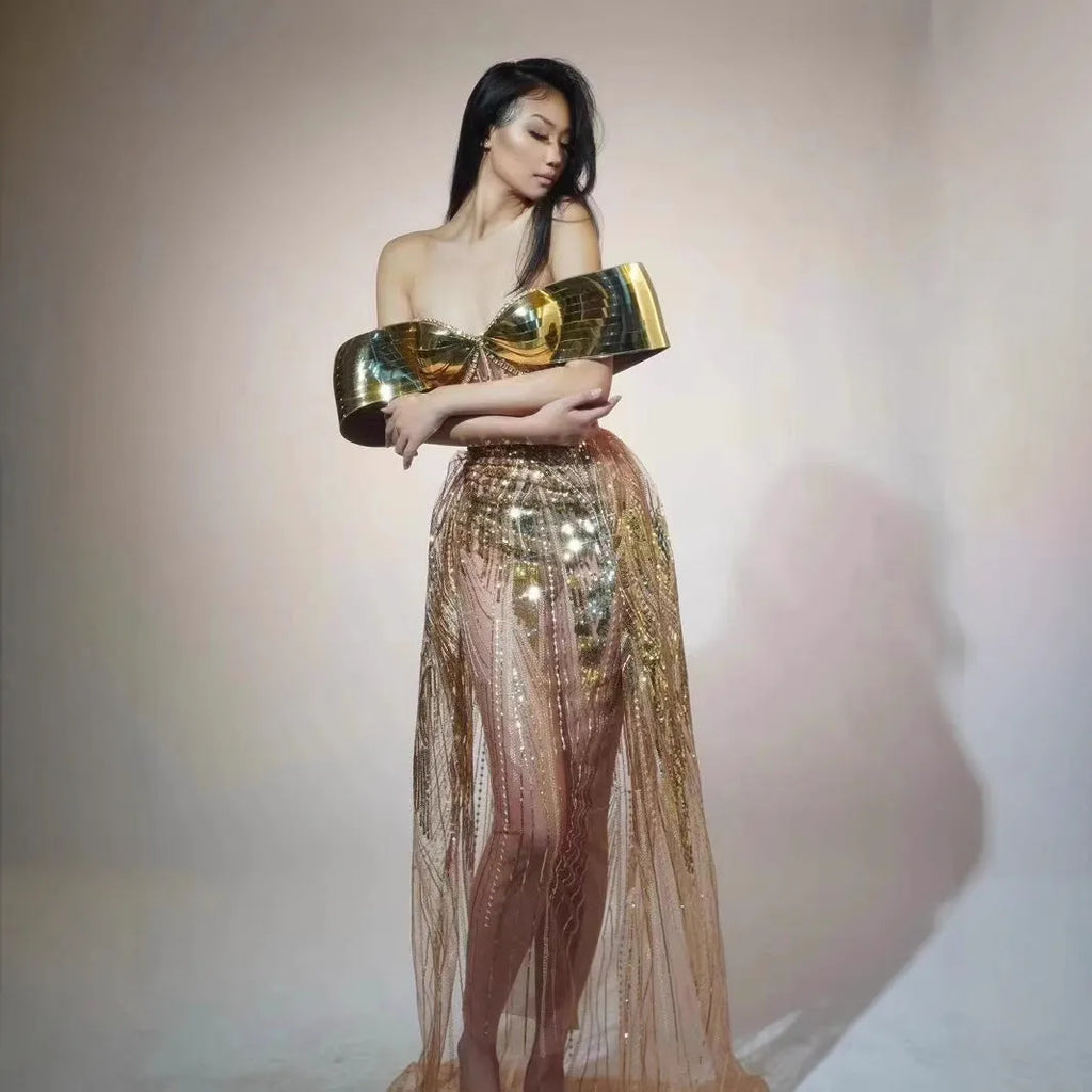 Gold sequined strapless long dress with a side split and tube top, shown on a model.