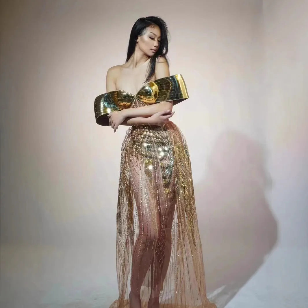 Gold sequined strapless long dress with a side split and tube top, shown on a model.