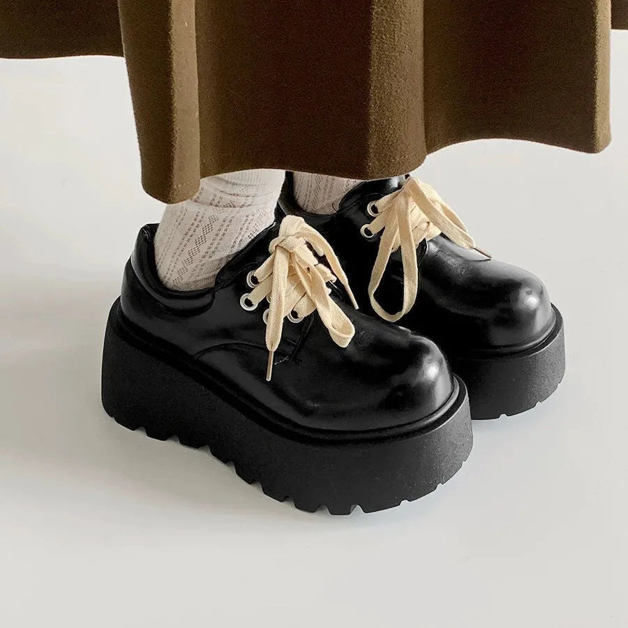 Women's matte black chunky heel lace-up shoes with a round toe and thick rubber sole.
