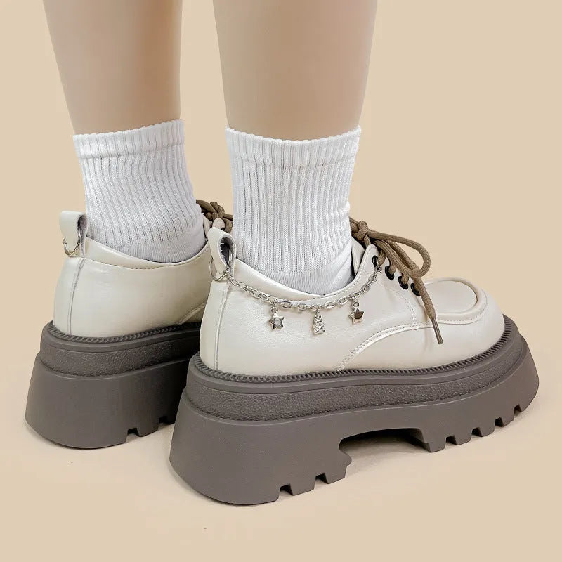 British-style white platform leather shoes with chunky heel and front lace-up closure