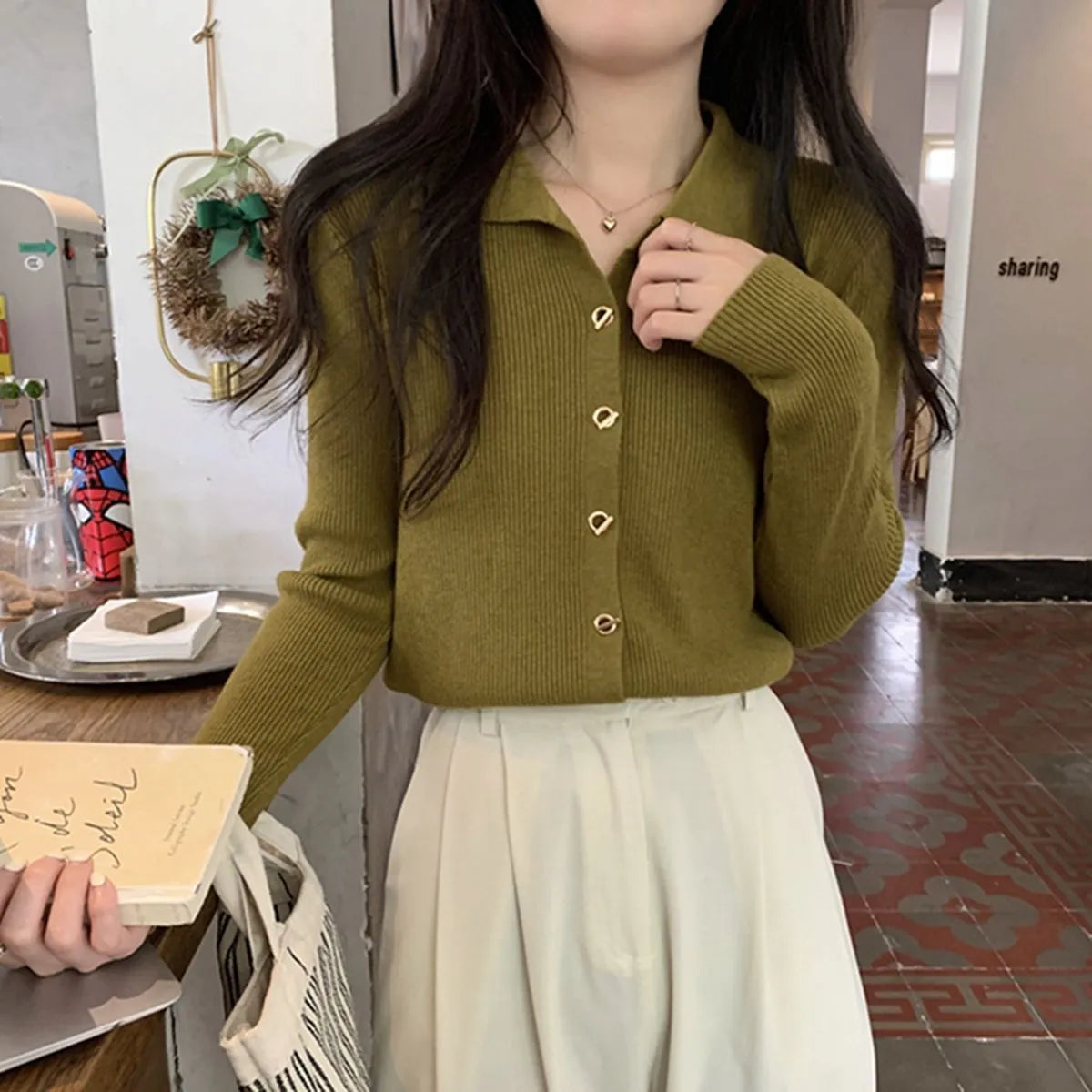 Long-sleeved beige viscose knit cardigan top shown on a hanger, demonstrating its loose fit and regular sleeve length.