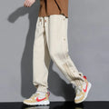Men's loose cotton blend sweatpants with ankle-tied cuffs in black colour