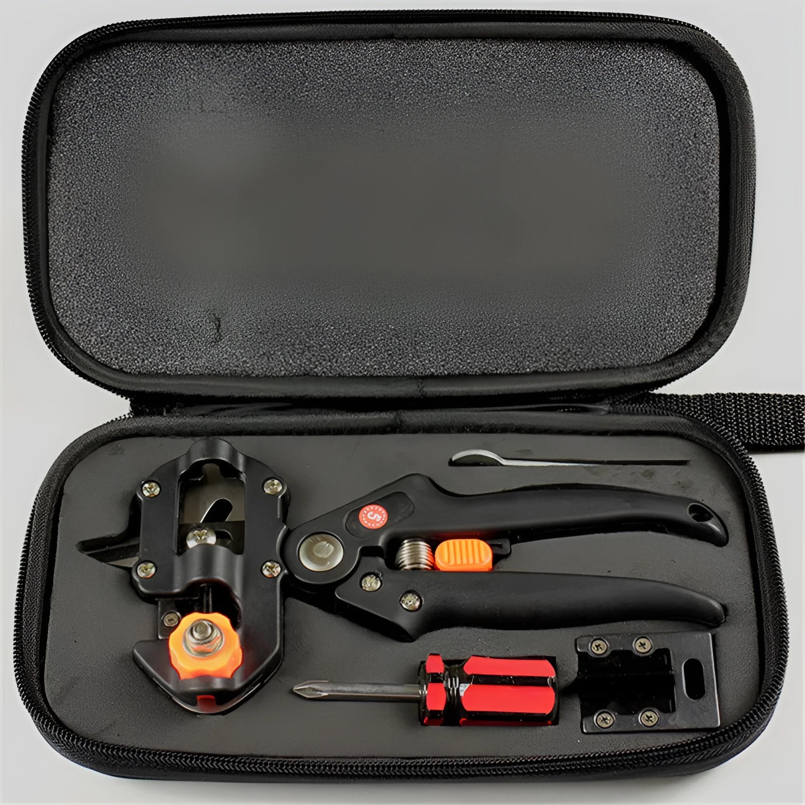 Handheld grafting scissors with black ABS handle and high carbon steel blade cutting a branch