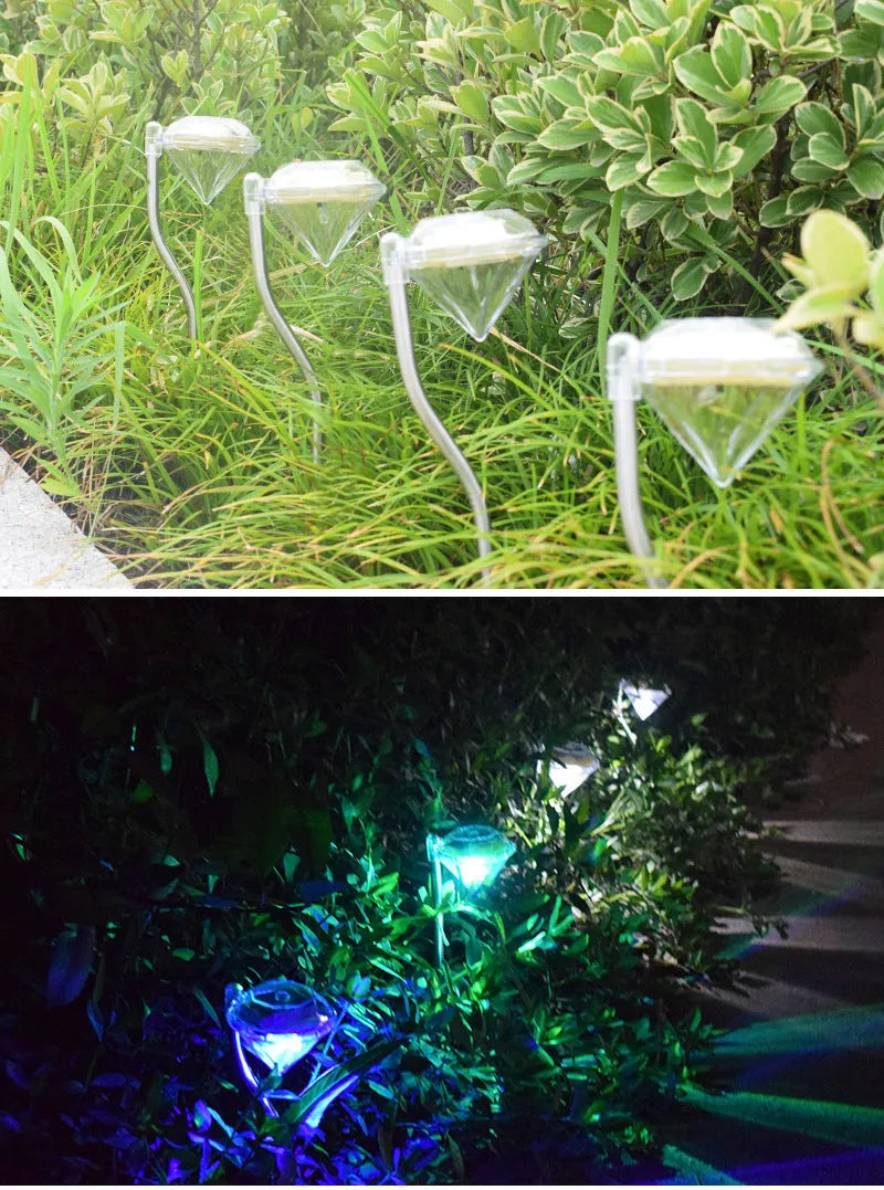 Solar powered diamond-shaped garden spotlight with adjustable angle on a grassy lawn.
