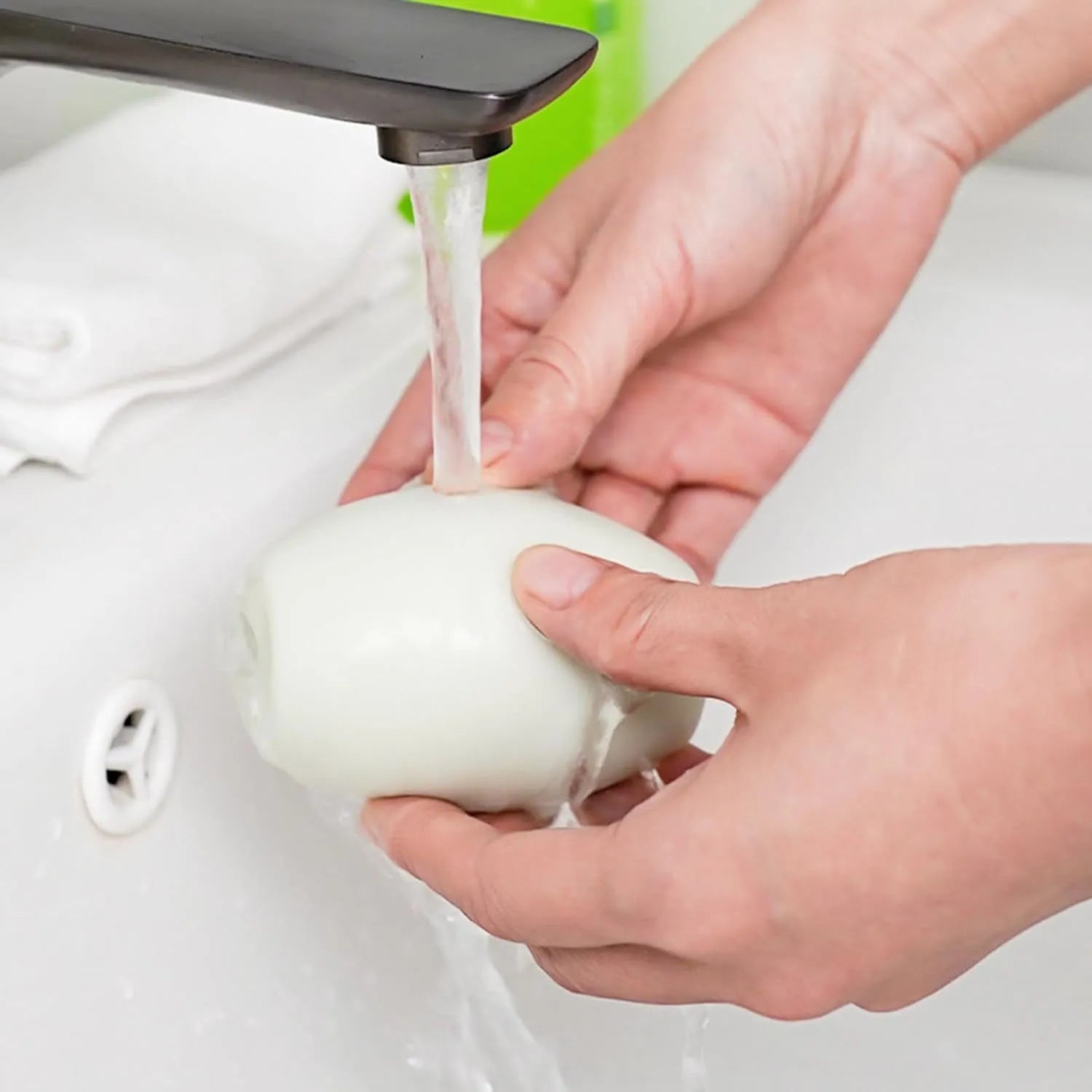 Green and white reusable gel lint roller ball for washing and removing pet hair