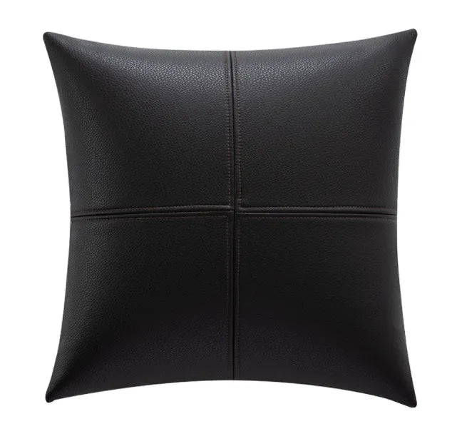 Soft cowhide leather pillow cover in a solid colour, shown in a Nordic-style room setting.