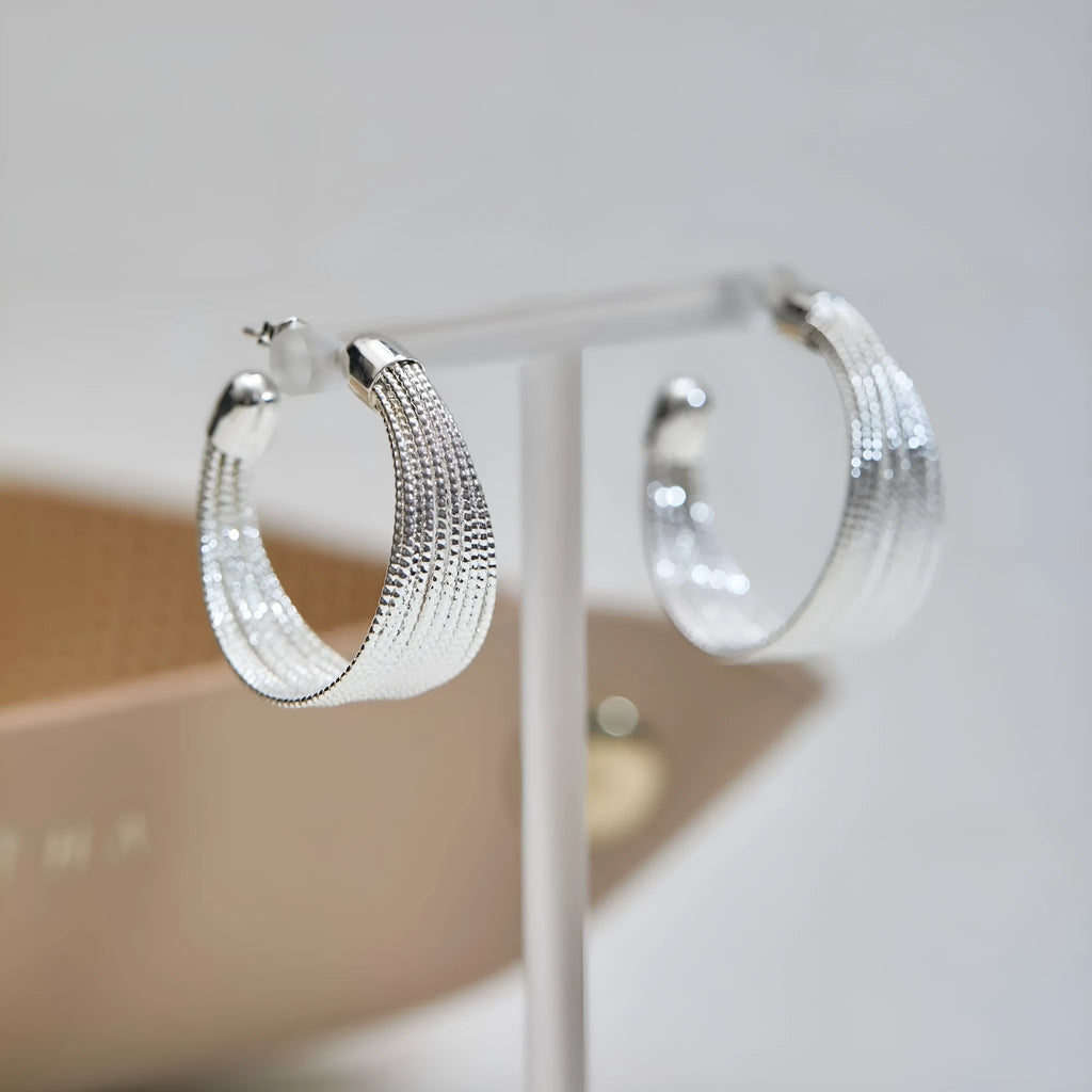 Geometric multi-layer copper earrings with an electroplated silver or gold finish, shown as studs and clips.