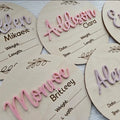 Square wooden baby birth information plaque with engraved details on a plywood base.