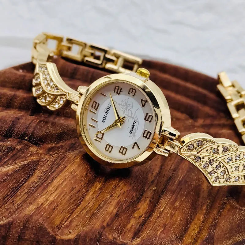 Stainless steel women's watch with round dial and vachette clasp, shown in gold, black, and white colour options.