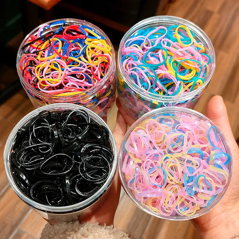 300 or 600 piece pack of baby hair ties in assorted colours, small TPU elastic bands for fine hair, supplied in a reusable container