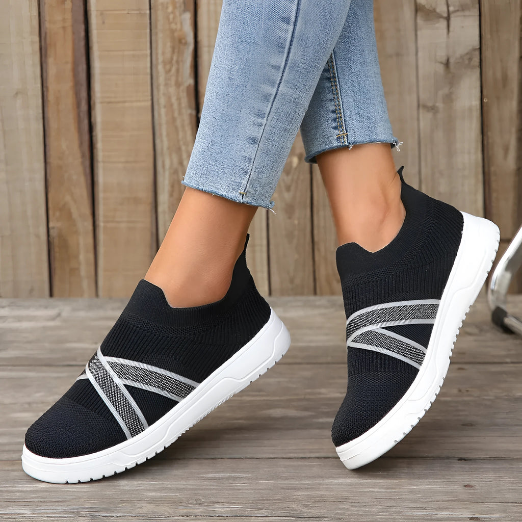 Women's black flat bottom flyknit mesh shoes with tassel detail, round toe, and rubber sole