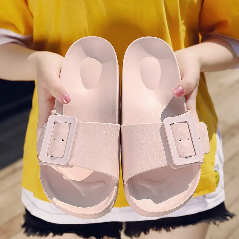 Women's grey blue EVA slippers with an adjustable silver buckle on the strap.