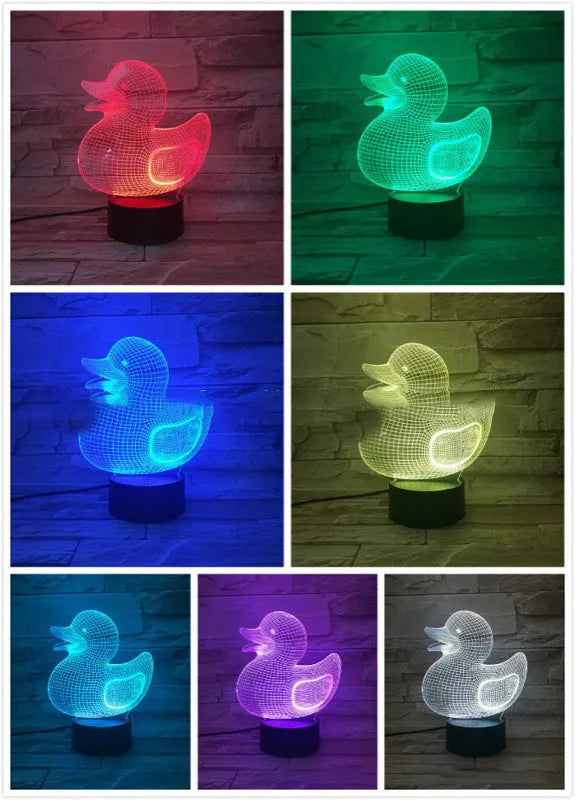 3D Little Yellow Duck night light glowing in multiple colours on a desk with remote control.