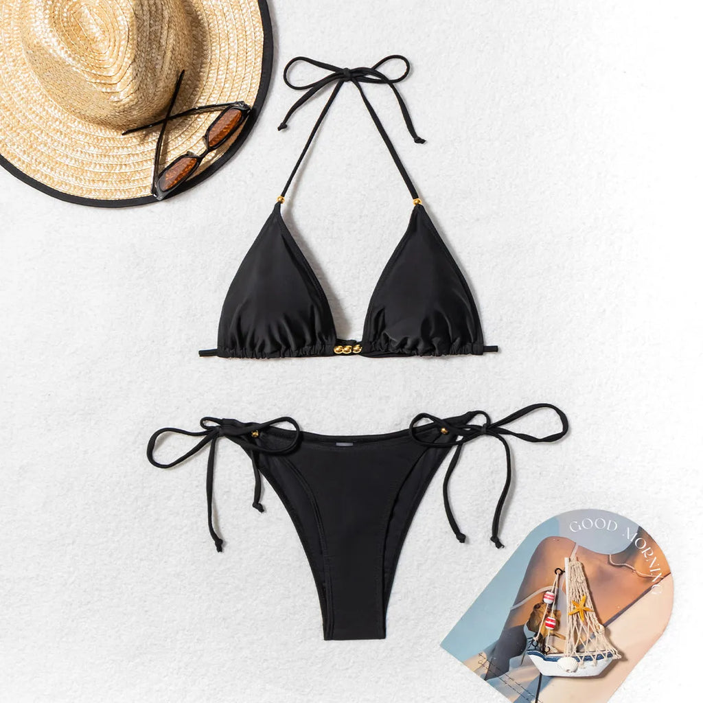 Black women's bikini swimsuit with metal bead detail on polyester fabric