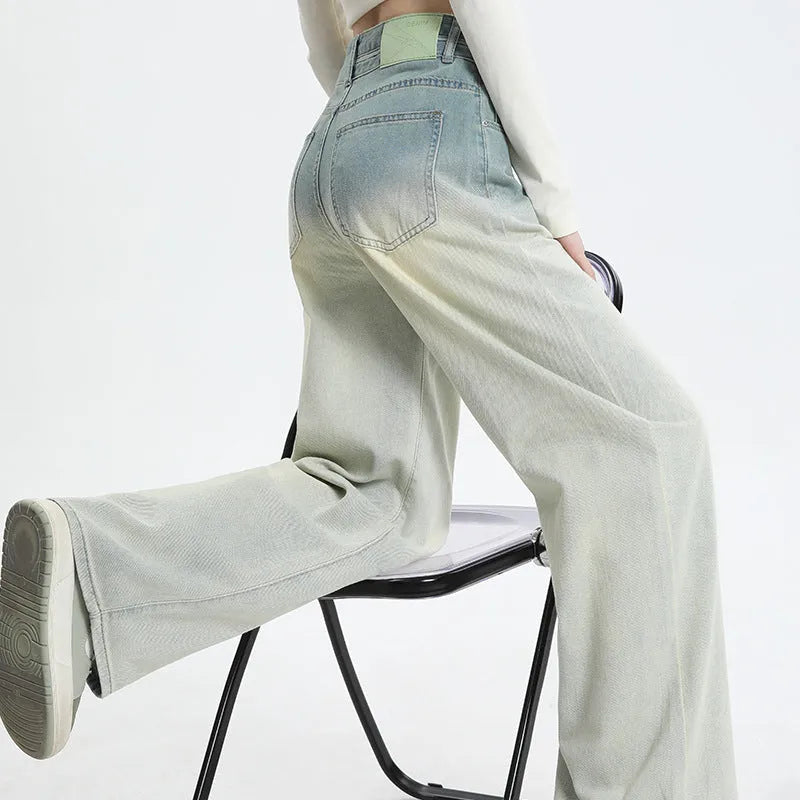 A pair of women's gradient blue straight-leg denim trousers with a wide leg opening, laid flat.