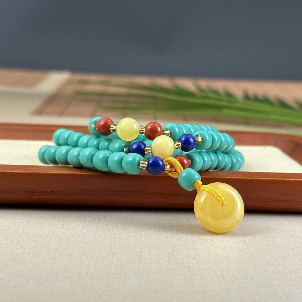 Turquoise stone pendant necklace with hand-woven mesh flower design on adjustable ball bead chain