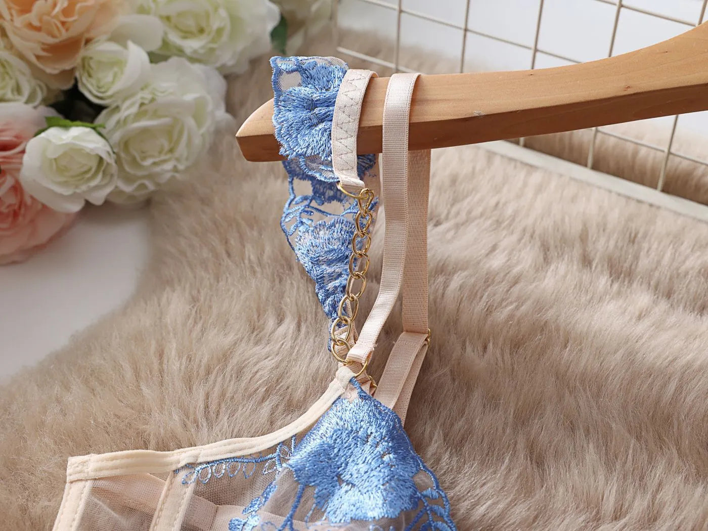 Light blue embroidered lace women's bra and brief set with transparent mesh panels.