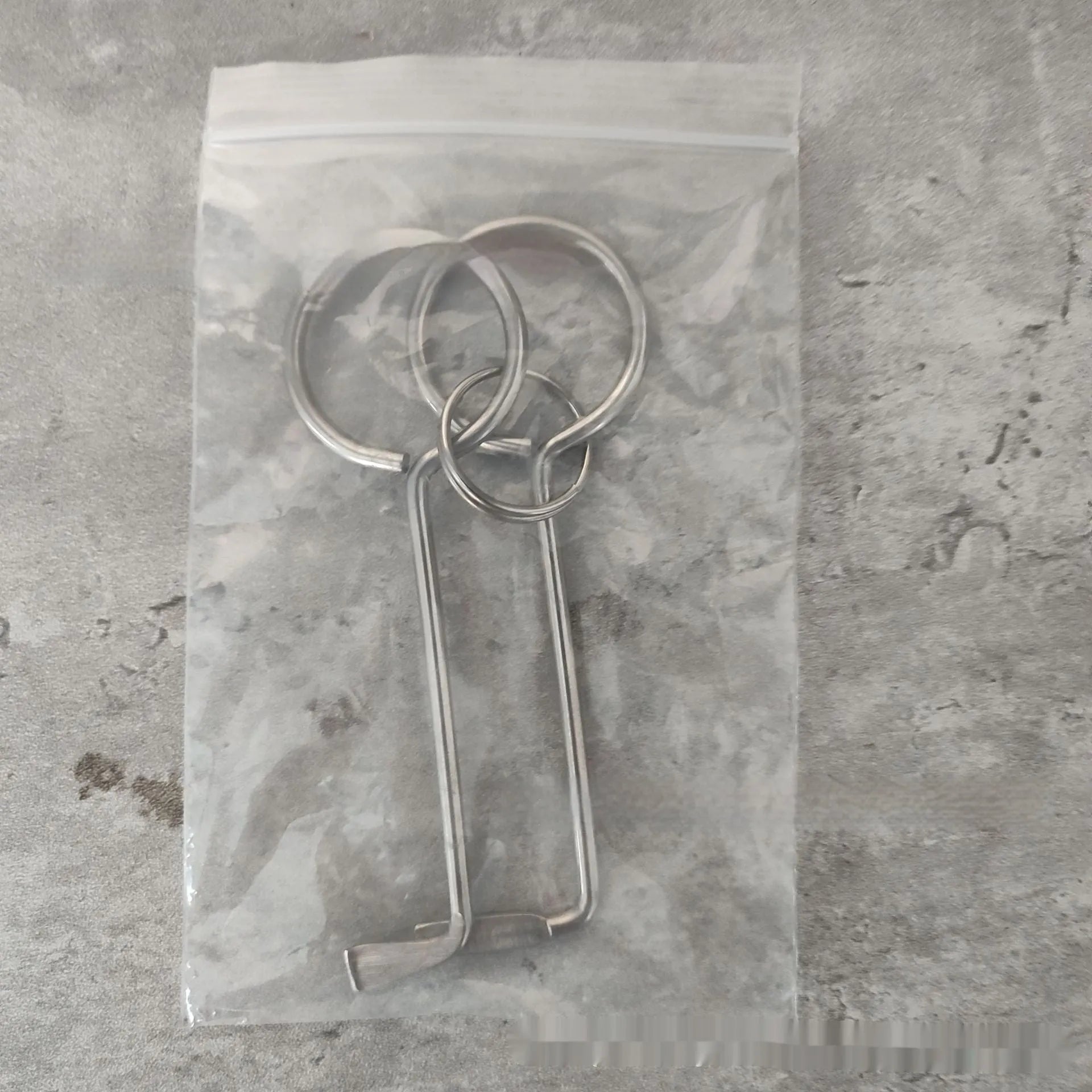 Two silver alloy wrench tools from a portable DIY and maintenance tool set.
