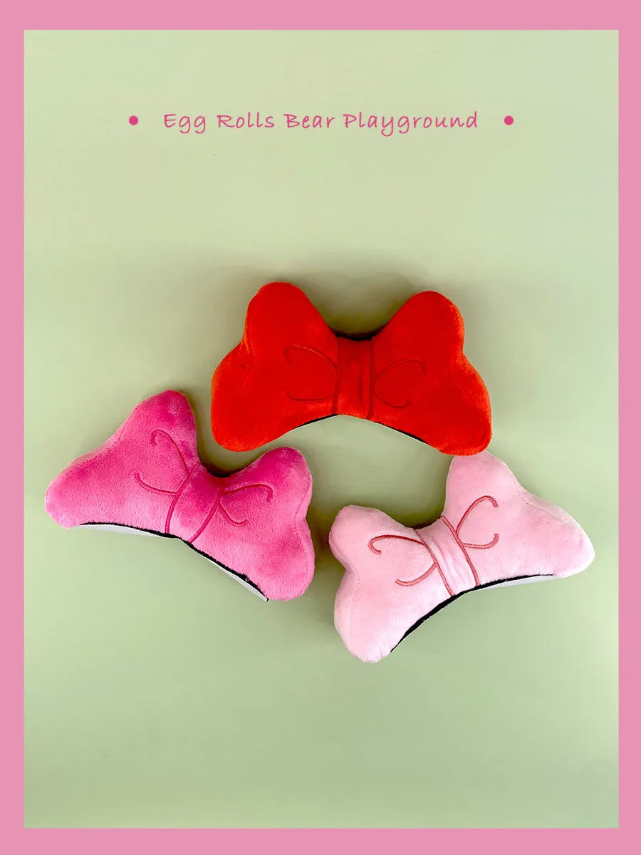 Plush bow tie helmet decoration in red or pink for motorcycle and ski helmet personalisation.
