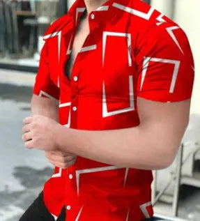 Man wearing a slim fit short sleeve shirt with a colourful 3D floral print, on a beach.