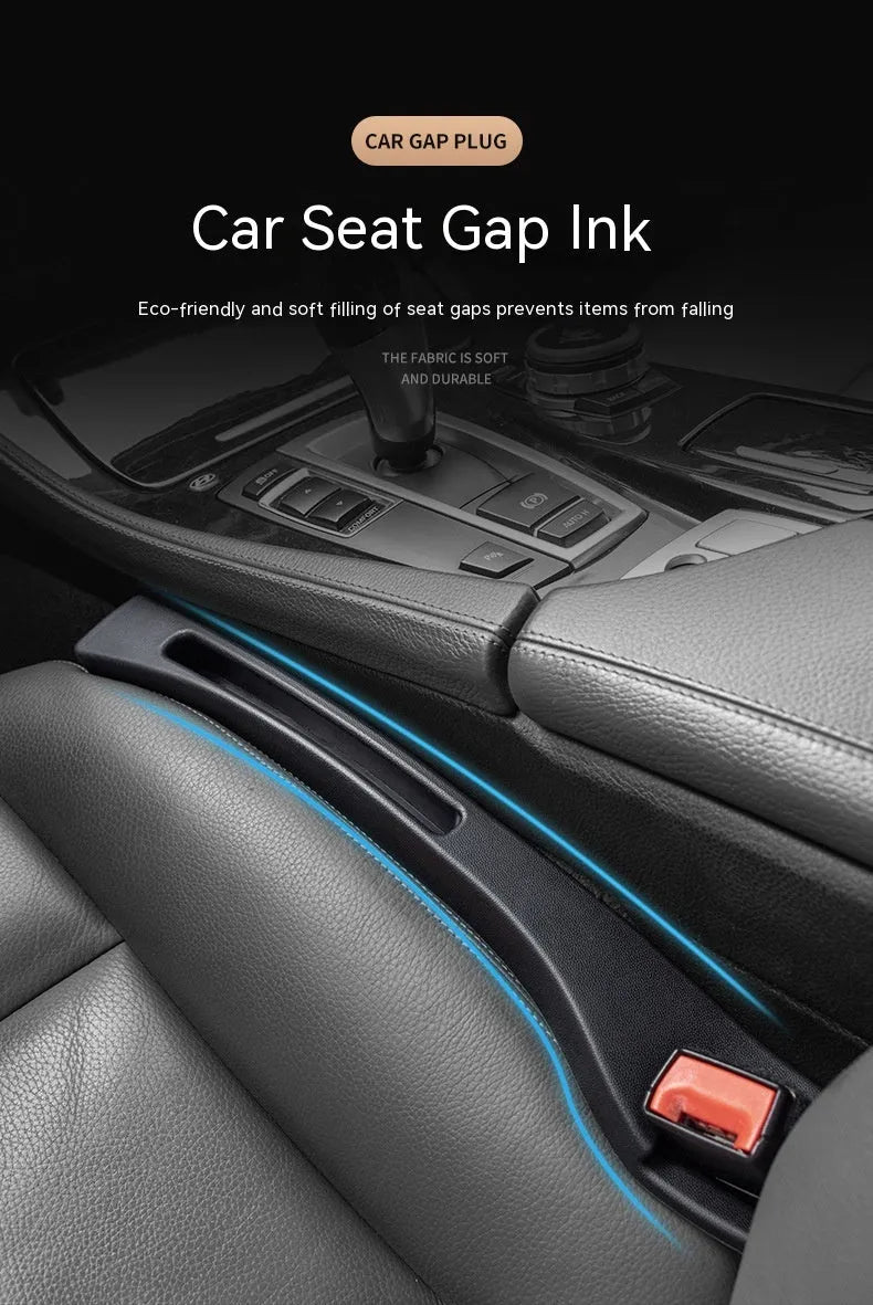Black plastic car seat gap storage box with handle inserted between vehicle front seats.