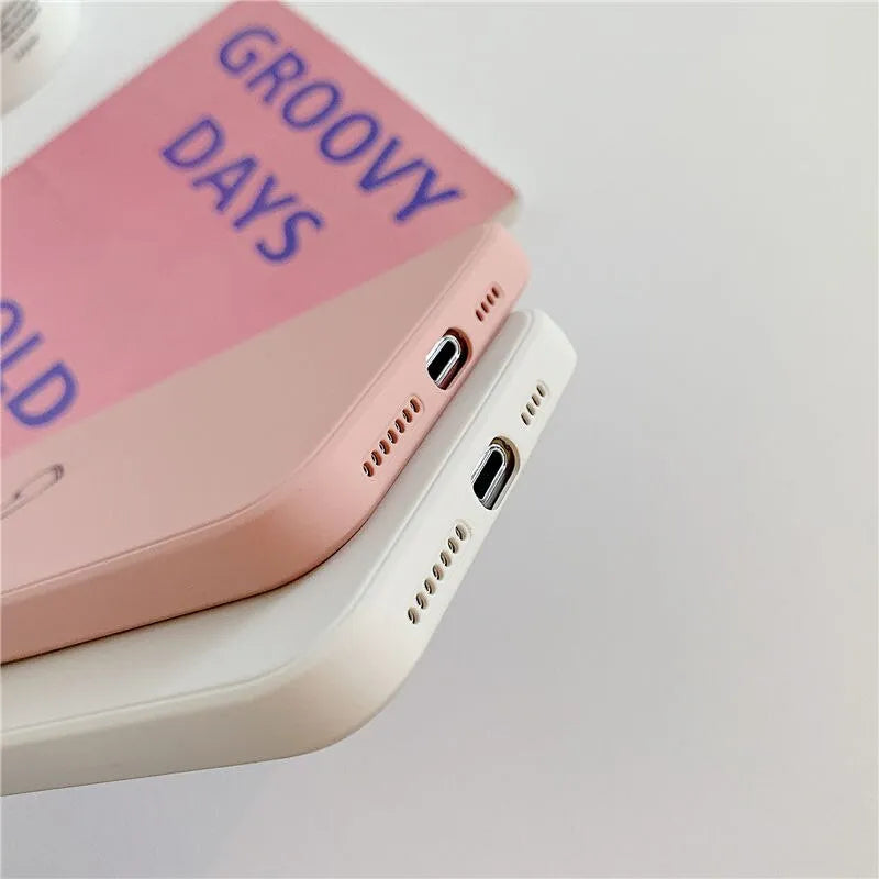 Solid colour silicone TPU back cover case for Apple iPhone on a table.